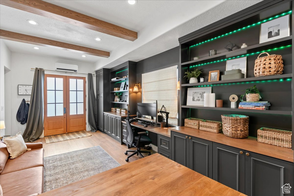 Office area with light wood-style floors, beamed ceiling, a wall unit AC, french doors, and recessed lighting