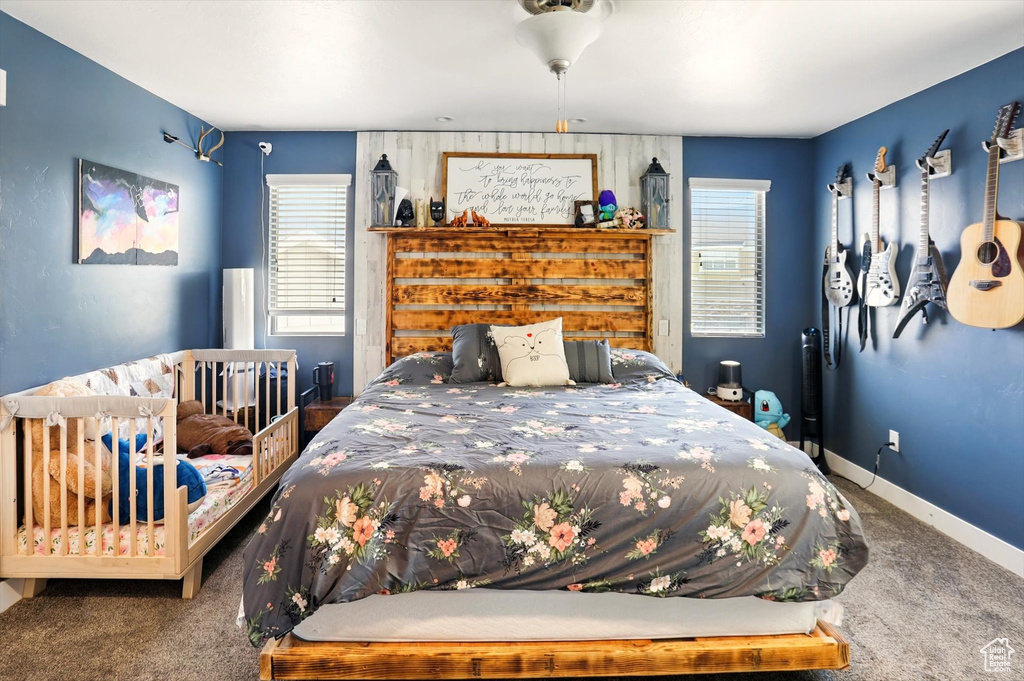 Carpeted bedroom featuring baseboards