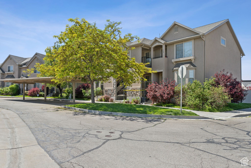 Multi unit property featuring stucco siding and a balcony