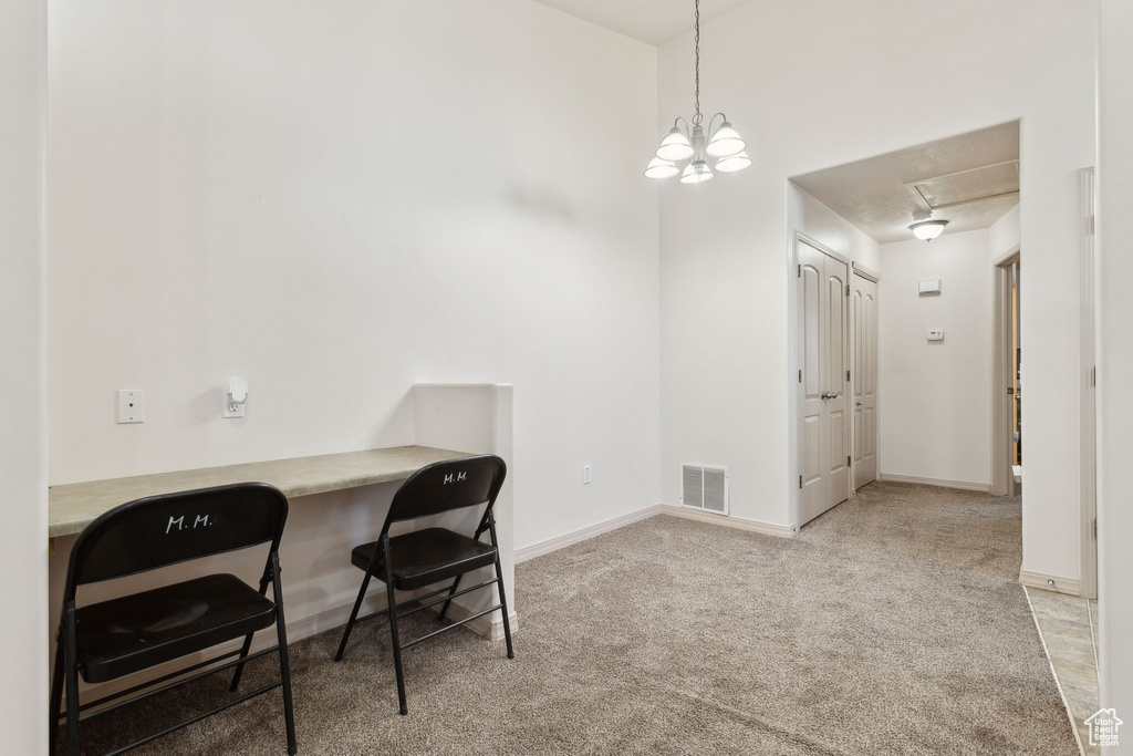 Home office with attic access, carpet, and baseboards