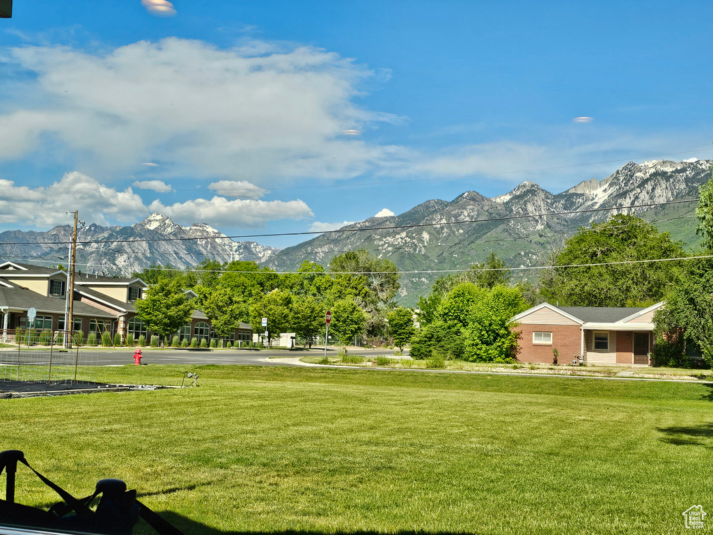 View of community with a mountain view and a yard