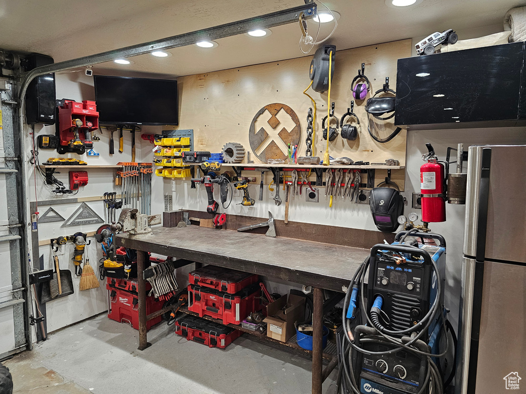 Garage with a workshop area and recessed lighting
