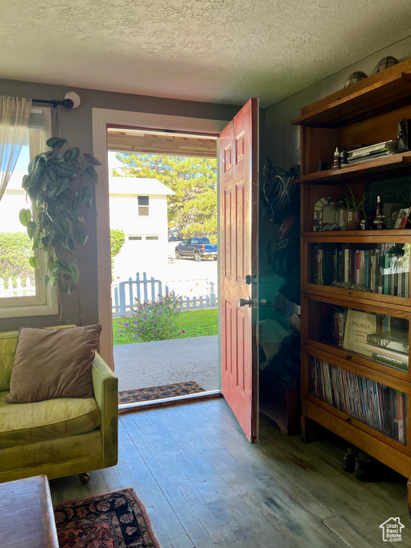 Entryway featuring hardwood / wood-style floors, healthy amount of natural light, and a textured ceiling