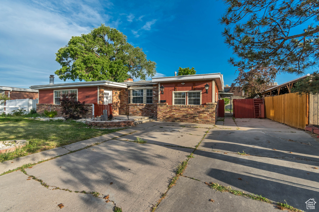 View of front of home with brick siding and a gate