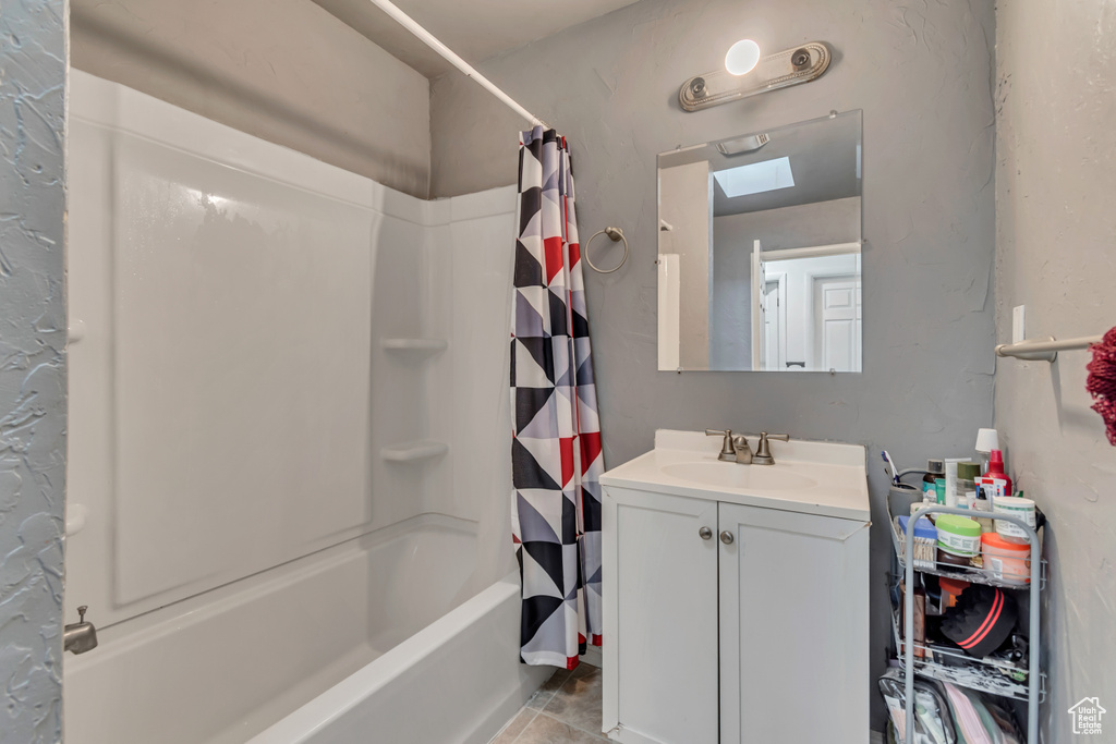 Bathroom with shower / tub combo with curtain, vanity, and tile patterned floors