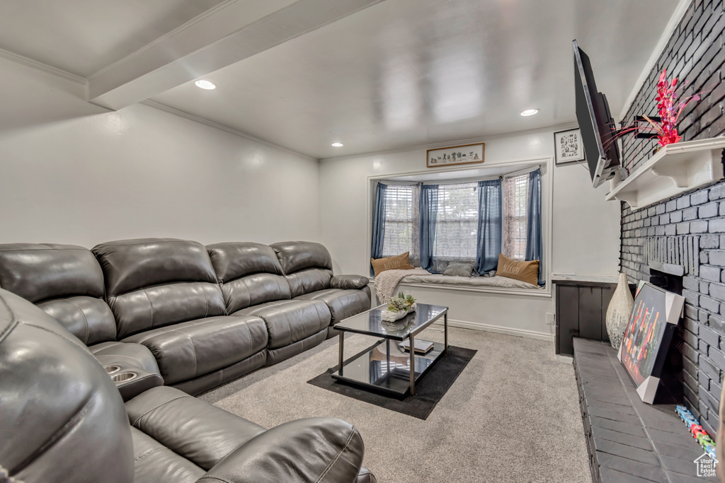 Living area featuring carpet flooring, a brick fireplace, recessed lighting, and crown molding