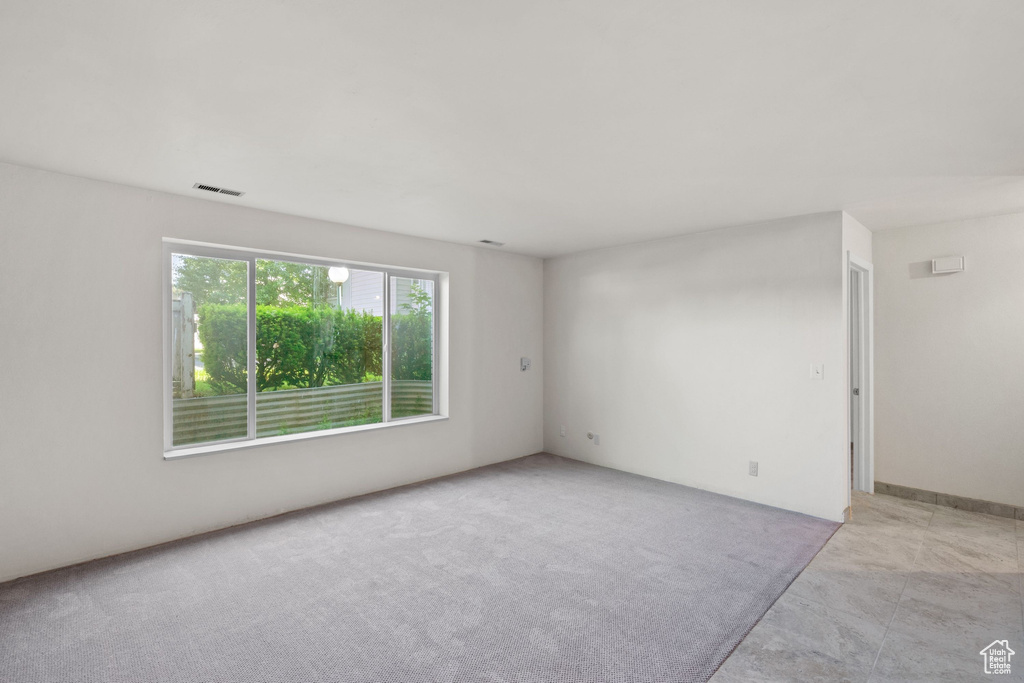Unfurnished room with light colored carpet