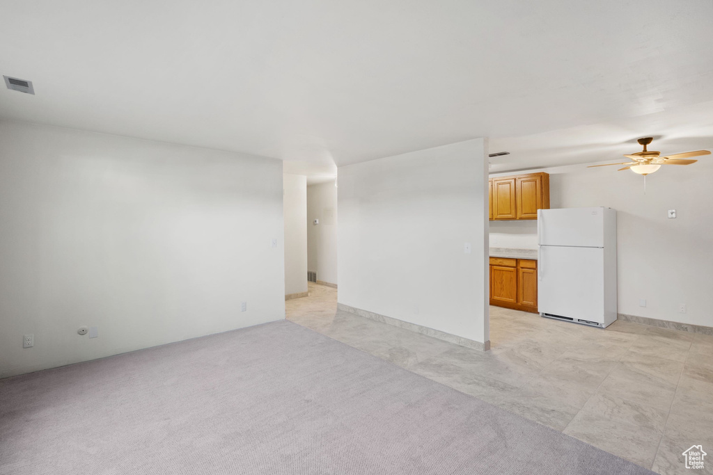 Unfurnished living room with a ceiling fan