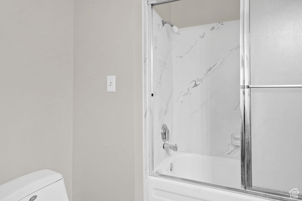 Bathroom featuring bathing tub / shower combination and toilet