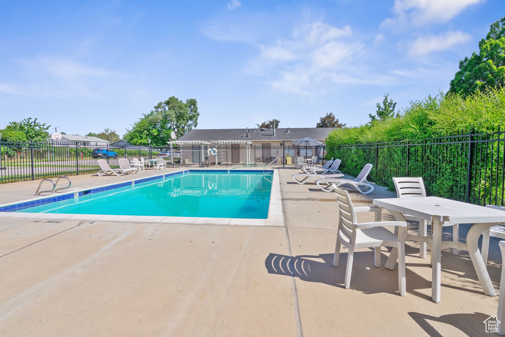 Community pool featuring a patio