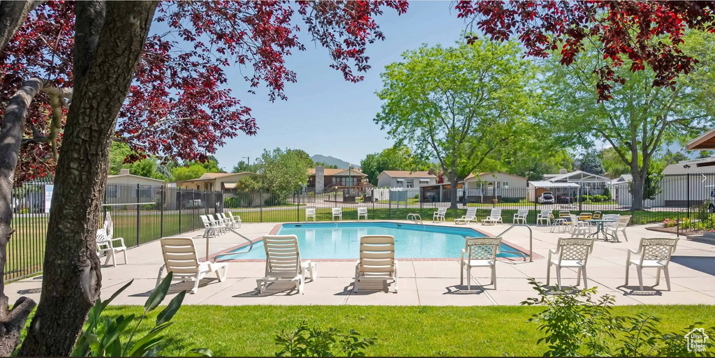 Community pool featuring a residential view and a patio area