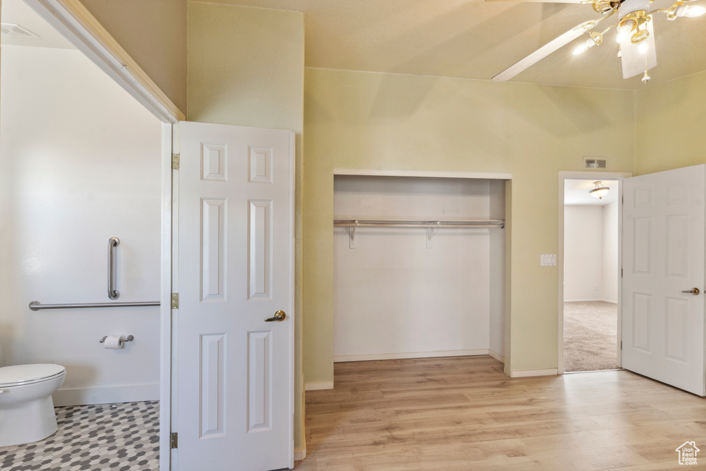 Unfurnished bedroom featuring a closet, light wood-type flooring, and baseboards