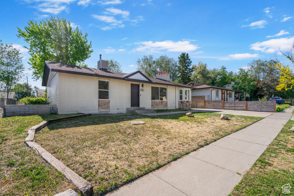 Single story home with brick siding, a chimney, and central AC