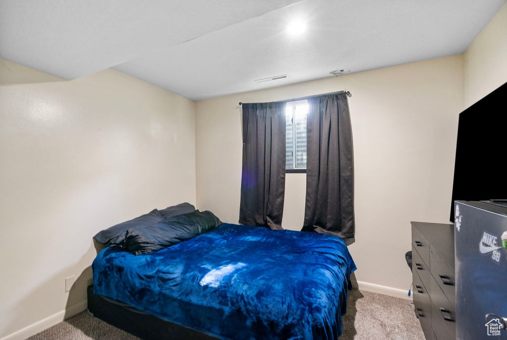 Bedroom featuring baseboards and carpet flooring