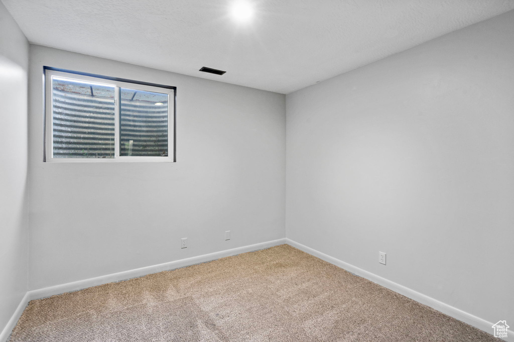 Unfurnished room with carpet floors and baseboards