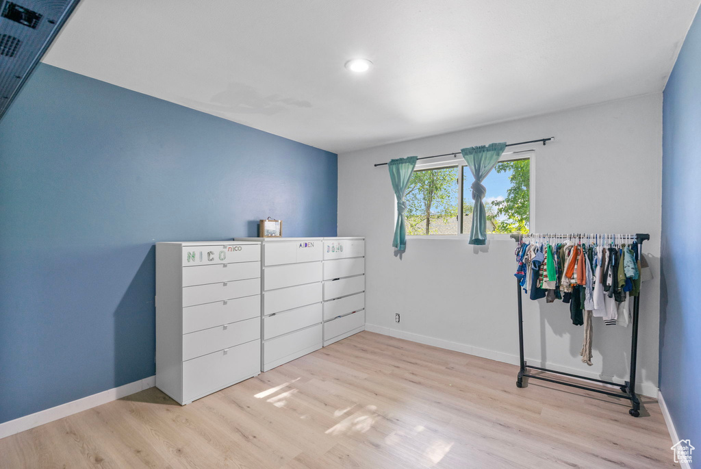 Unfurnished bedroom featuring wood finished floors, baseboards, and recessed lighting