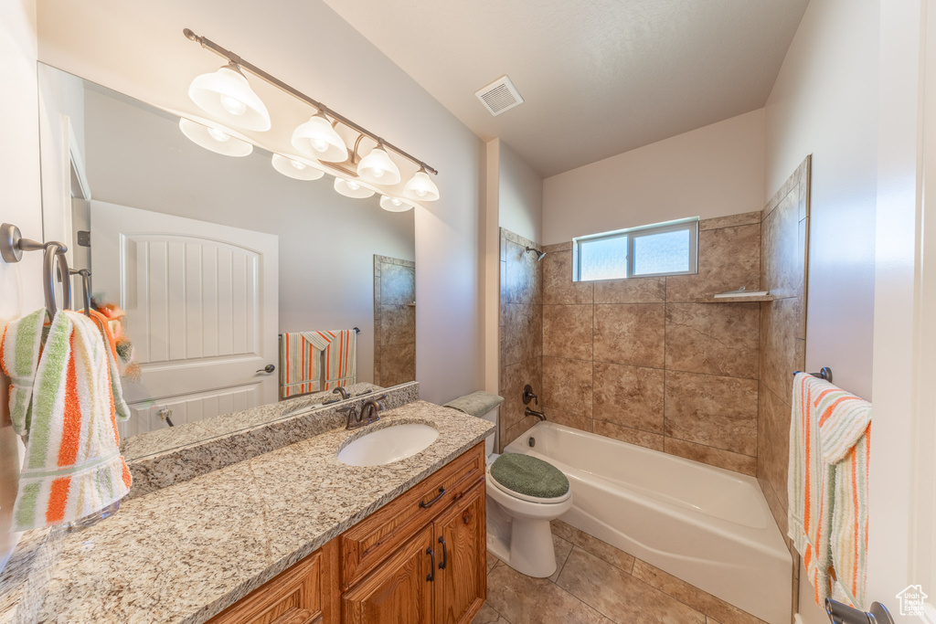 Bathroom with vanity, toilet, shower / washtub combination, and tile patterned floors