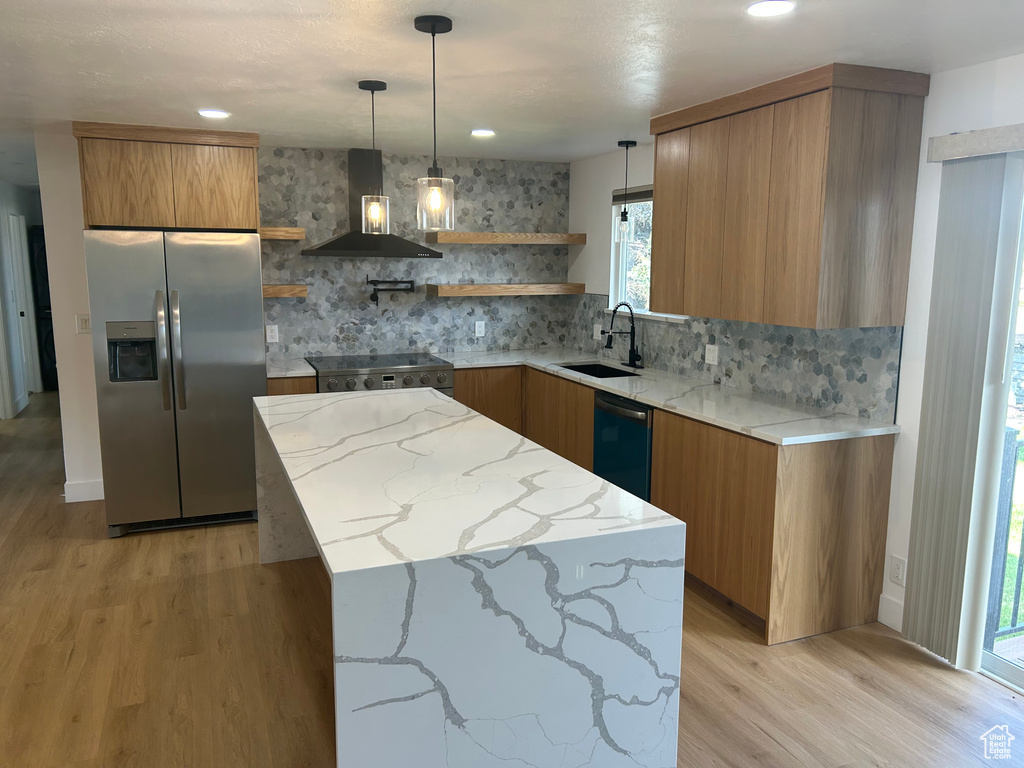 Kitchen featuring stainless steel fridge with ice dispenser, wall chimney range hood, open shelves, a sink, and brown cabinets