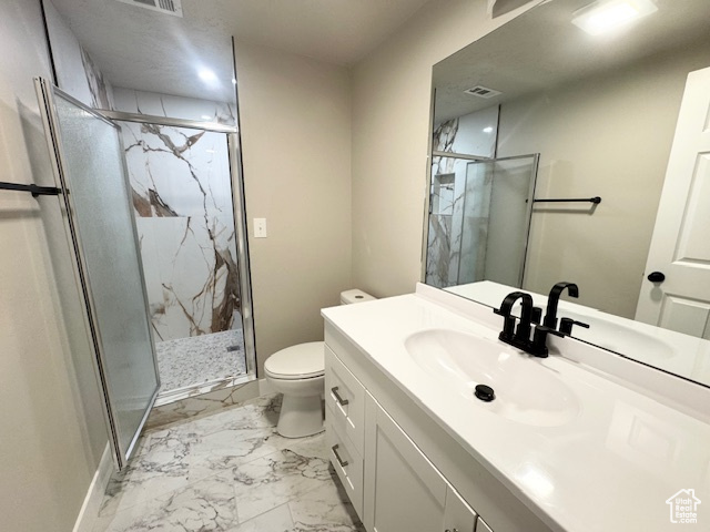 Full bathroom with toilet, marble finish flooring, vanity, and a marble finish shower