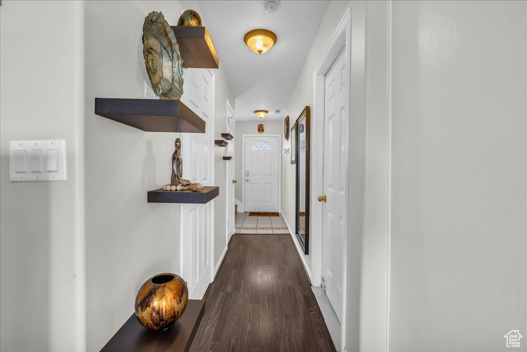 Hallway with wood finished floors and baseboards