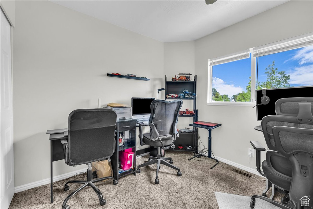 Office space with carpet and baseboards