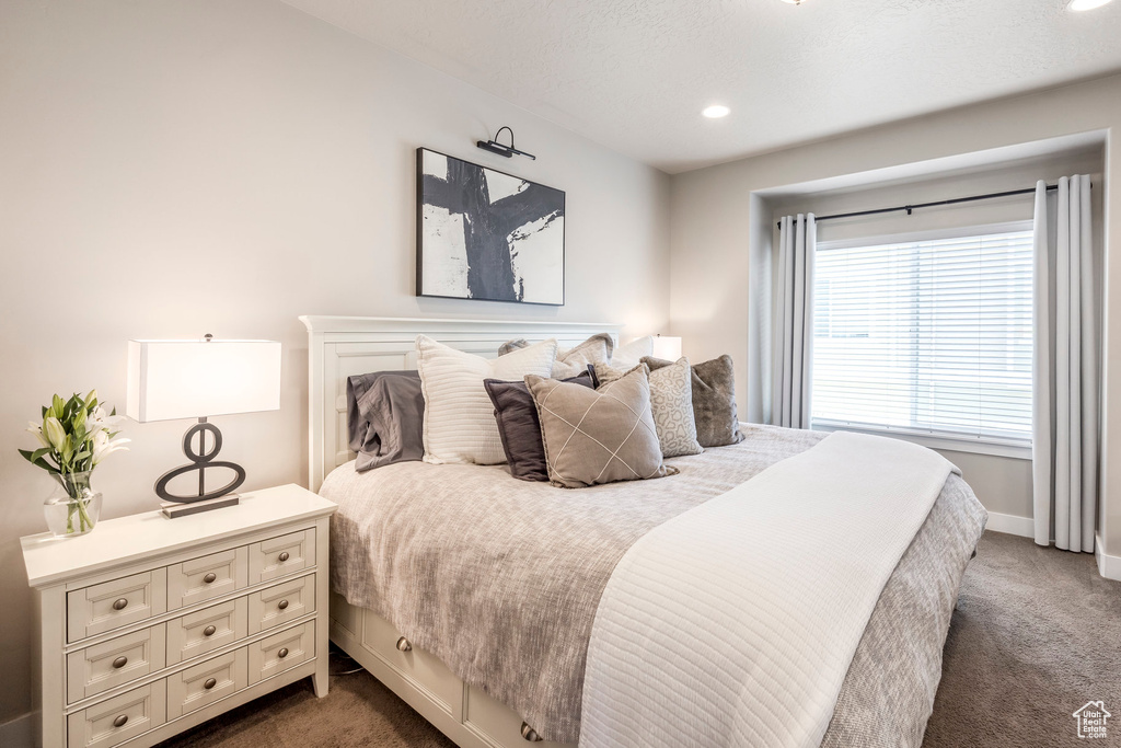Bedroom featuring dark colored carpet, recessed lighting, and baseboards