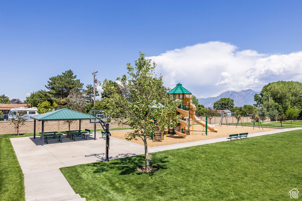 Community jungle gym with a yard, a mountain view, and a gazebo