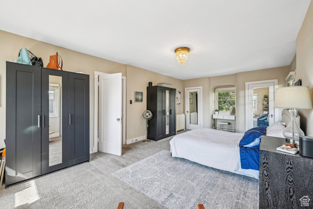 Bedroom featuring light colored carpet and baseboards