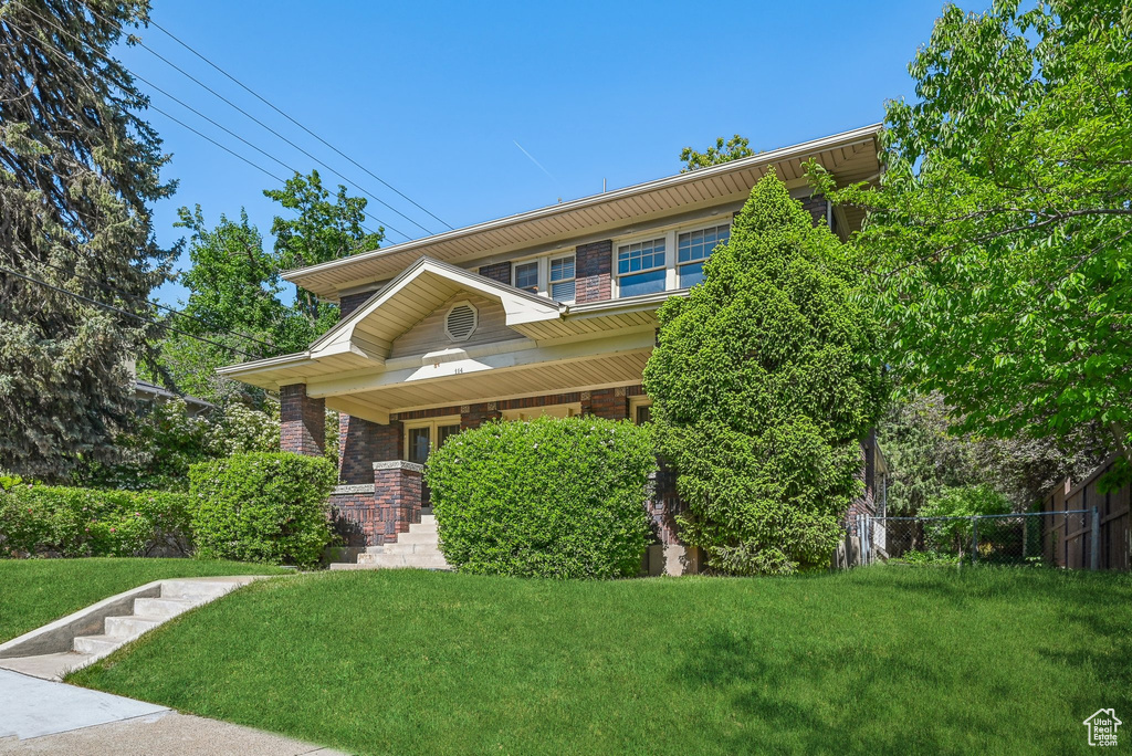 View of front of property with brick siding and a porch