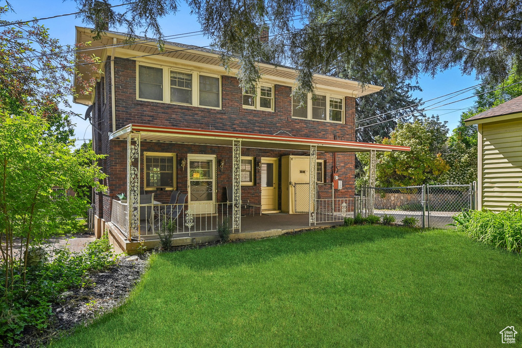 View of front of home featuring covered porch and brick siding