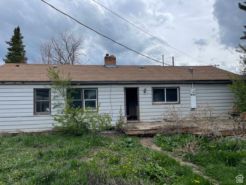 Rear view of house with a chimney