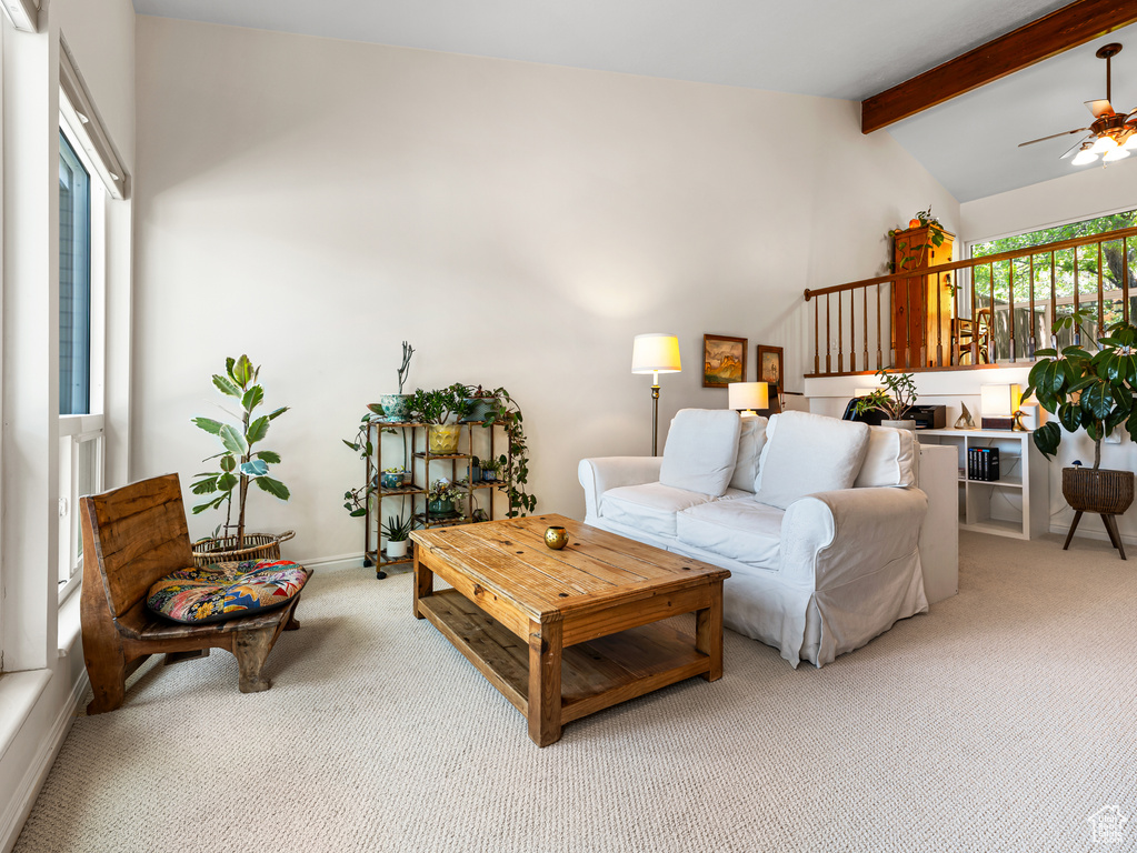 Living room with light colored carpet, ceiling fan, and baseboards