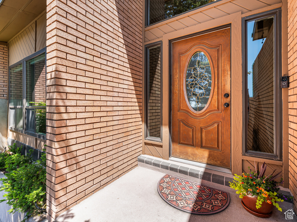 View of exterior entry featuring brick siding