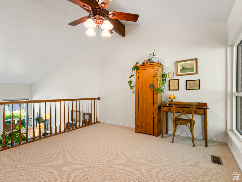 Living area featuring ceiling fan, carpet flooring, and baseboards