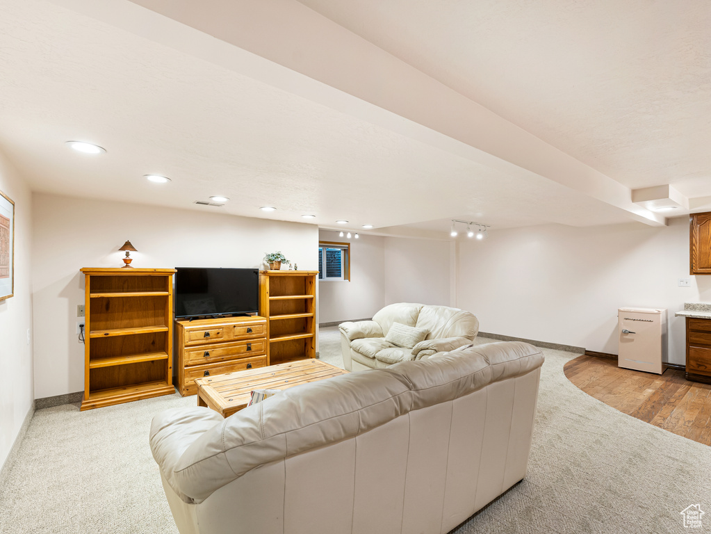 Living room featuring light colored carpet, baseboards, and recessed lighting