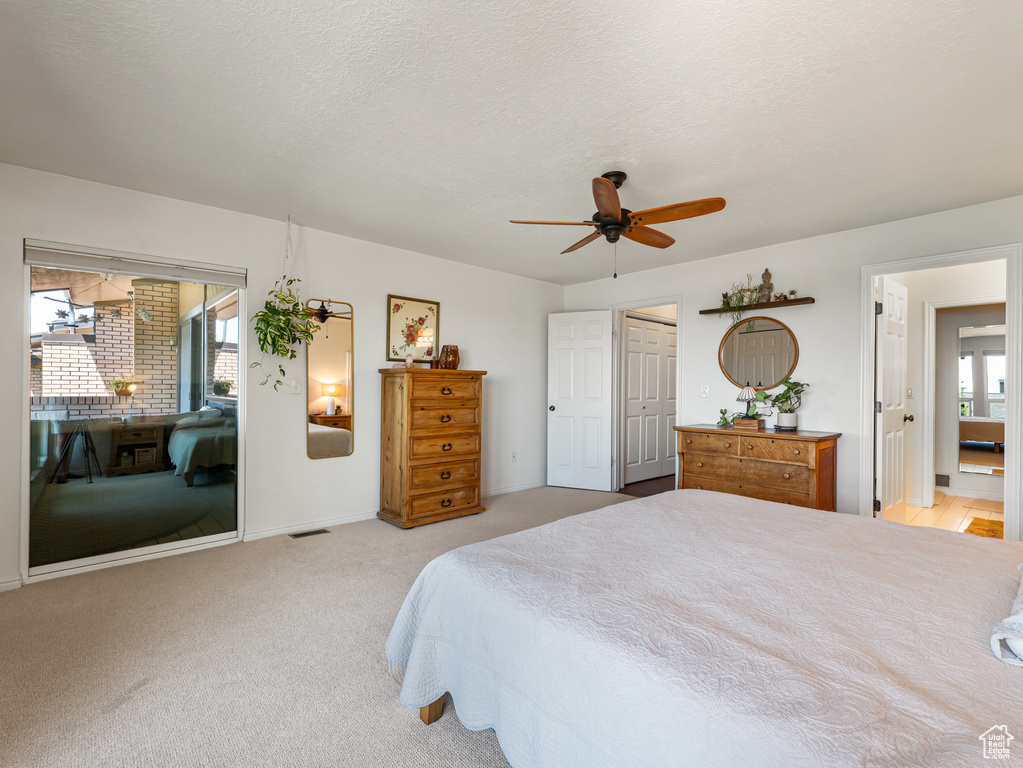 Bedroom with access to outside, light carpet, a ceiling fan, and baseboards