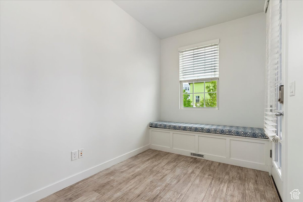 Unfurnished room with light wood-type flooring and baseboards