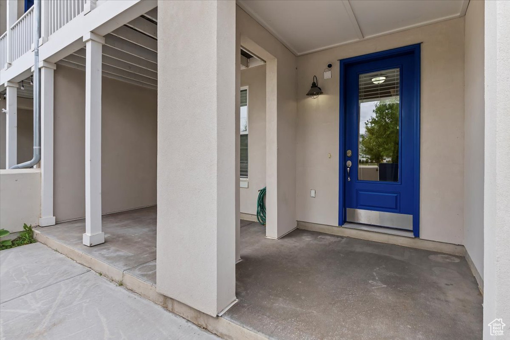 Doorway to property featuring stucco siding