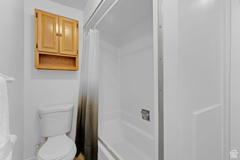 Full bathroom with toilet and shower / bath combo