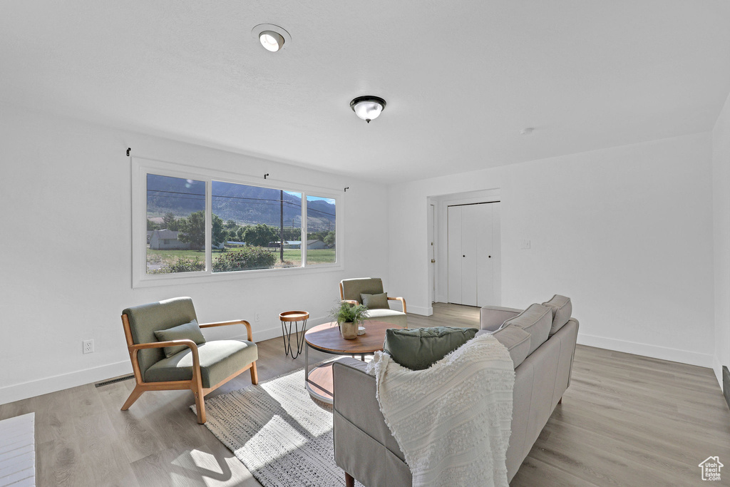 Living room with baseboards and light wood finished floors