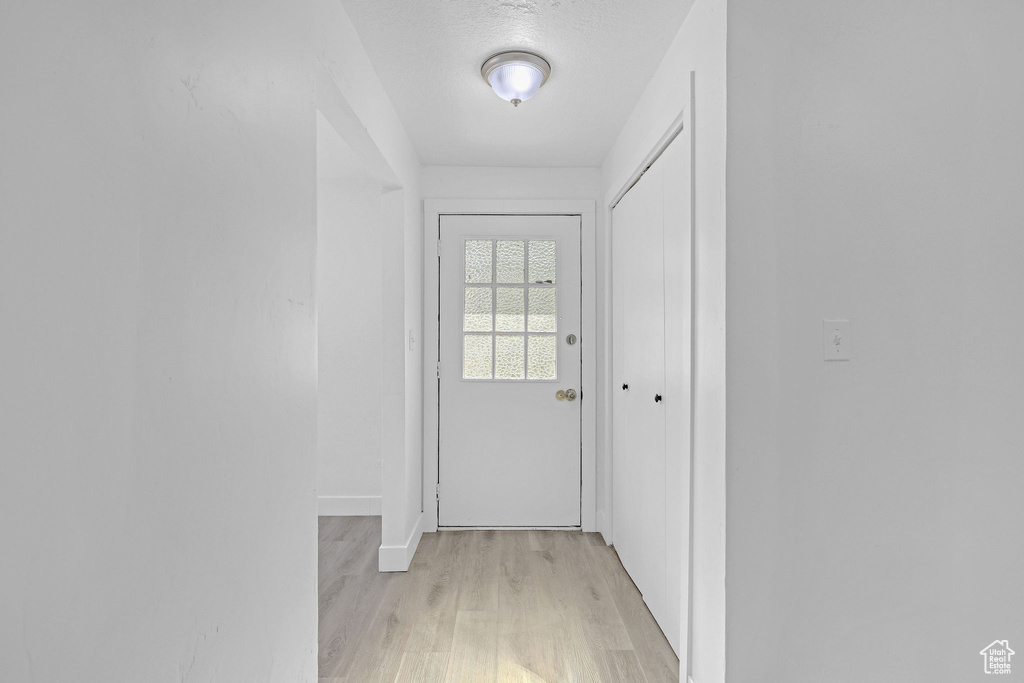 Entryway featuring light wood-style floors and baseboards