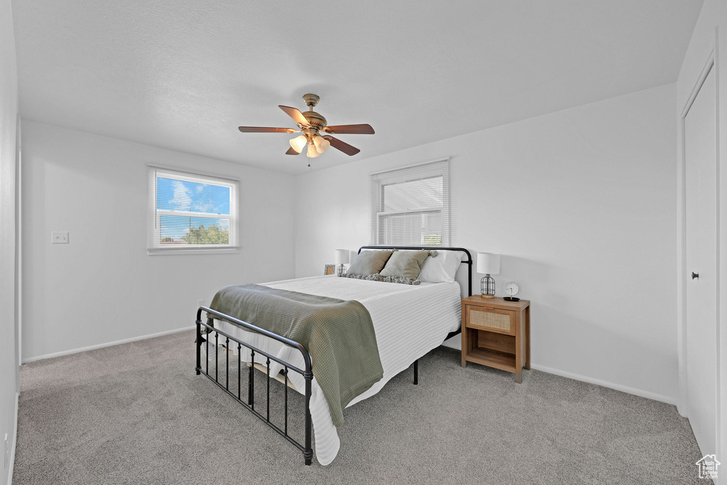Bedroom featuring carpet floors, baseboards, ceiling fan, and a closet