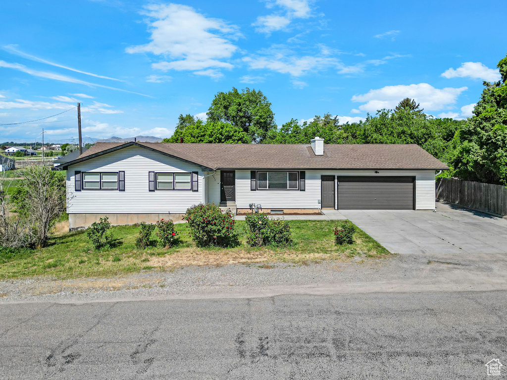 Ranch-style home with an attached garage and concrete driveway