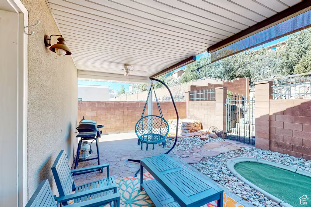Fenced backyard with a patio area and grilling area