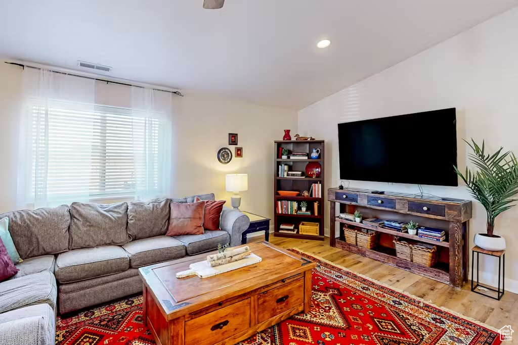 Living room featuring wood finished floors and recessed lighting
