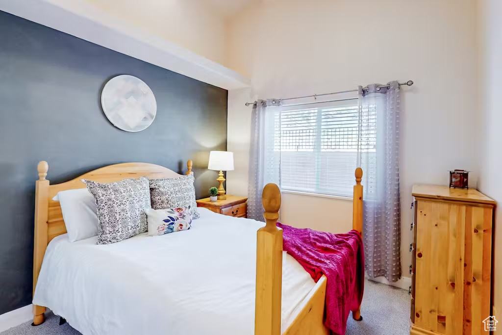 Carpeted bedroom featuring baseboards