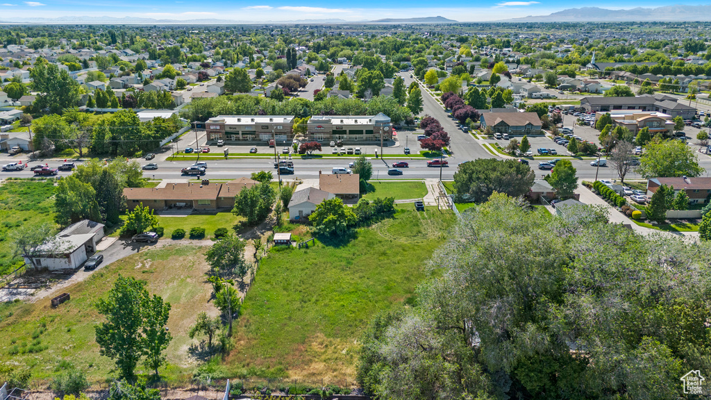 Aerial view of property's location with a mountainous background and nearby suburban area