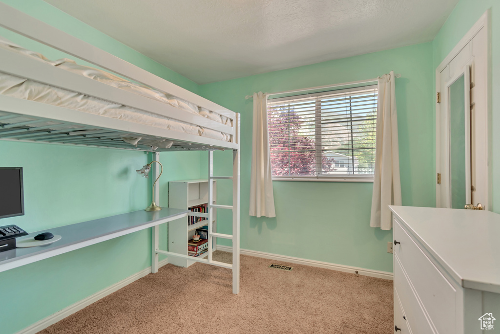 Carpeted bedroom featuring baseboards