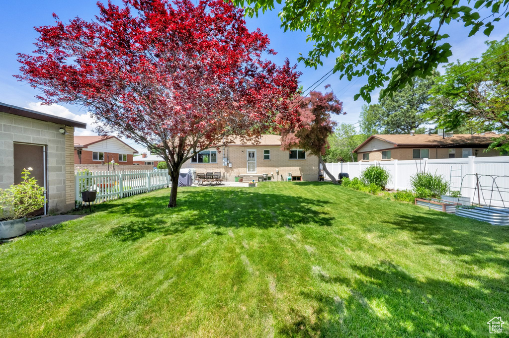 View of yard with a garden and a patio area