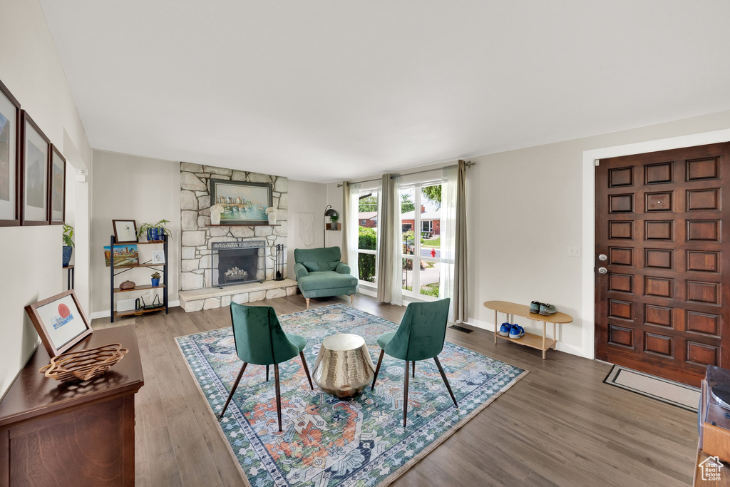 Living area featuring a fireplace, wood finished floors, and baseboards